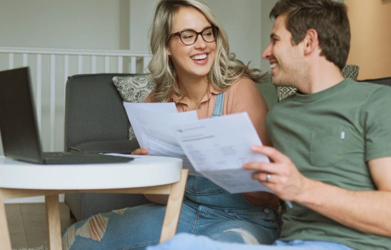 JBSP Mortgage Widget | Couple looking at paperwork infront of a laptop