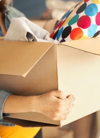 Moving Home Widget | Woman carrying boxes with belongings in